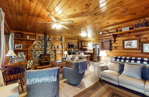 Valois House | 1-acre lakefront log cabin with dock, 50 ft water frontage, hot tub, & deck