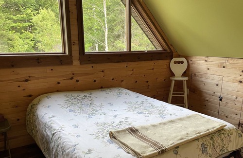 Notre-Dame-Des-Bois Cabin | A cozy rustic mountain side cabin with a small river on the property.