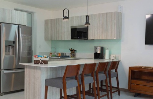 Ciudad Cariari Apartment | Accommodation in Cariari: 2 bedrooms, kitchen, living room, garden, BBQ, and pool in the clubhouse.