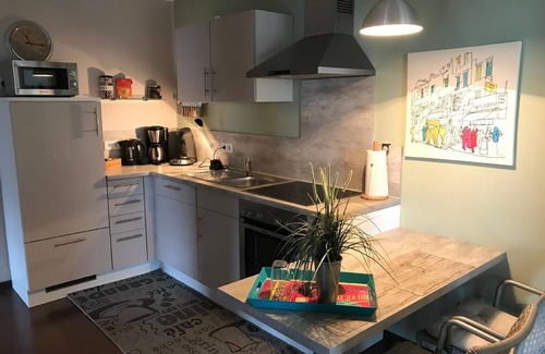 Punderich Apartment | An apartment with a terrace and a roofed balcony, with a view of the Schiefer