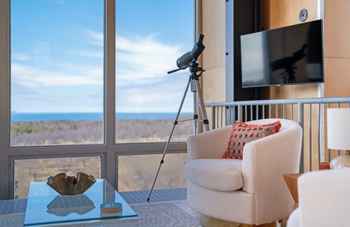 Northport House | Award-winning 9-level Chameleon House in Leelanau County. A modern-industrial masterpiece with reflective siding, rooftop deck, and epic Lake Michigan views near beaches and Fishtown.