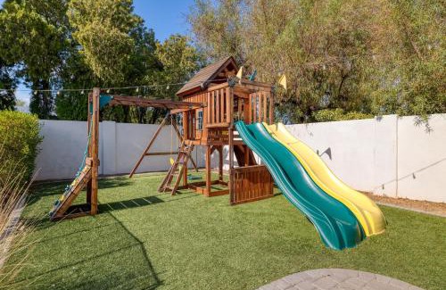 Raskin Estates Villa | Backyard Pool PuttingGreen Playground Modern 5BDR White Agate by AvantStay