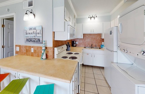 Panama City Beach Condo | Beachfront condo with a kitchen, located in a gated resort featuring pools, hot tub, and a tiki bar!