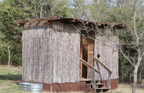 Pipe Creek RV Rental | Canvas Tipi on wooden deck overlooking a season creek.