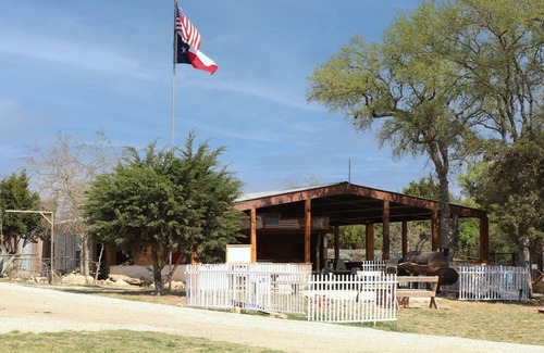 Pipe Creek RV Rental | Canvas Tipi on wooden deck overlooking a season creek.