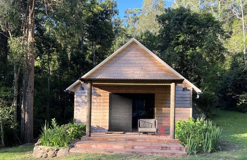 Cedar Brush Creek Cabin | Cedar cabin in serene cool setting in rainforest bush, traditional luxe