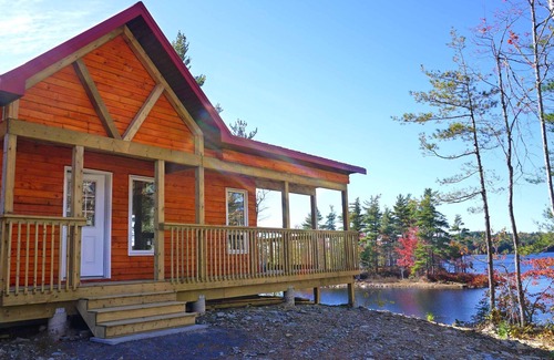 Queens House | Chalet directly on the lake, central storage, incl. access to private island