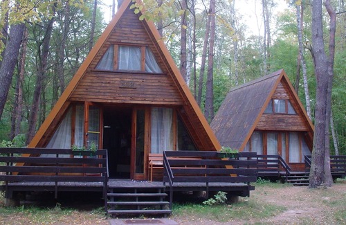Sierakow Ski Chalet | Chalet on a holiday park in a wooded area by the lake and near a beach.