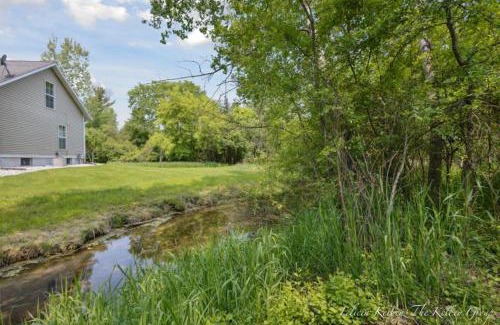 Howard City House | Charming Farmhouse by Stream and fire pit