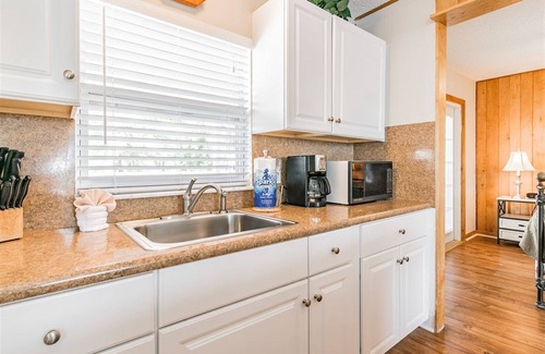 Madeira Beach Cottage | Charming Upstairs Unit in a Cottage, steps to the beach. Across from John's Pass