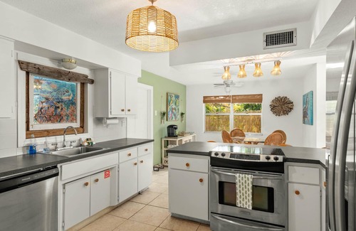 River Isles House | Coconut cove - peaceful garden retreat with HEATED pool on canal near the beach!