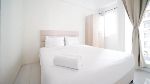 Surabaya Apartment | Compact and Tidy Studio at Puncak Dharmahusada Apartment By Travelio