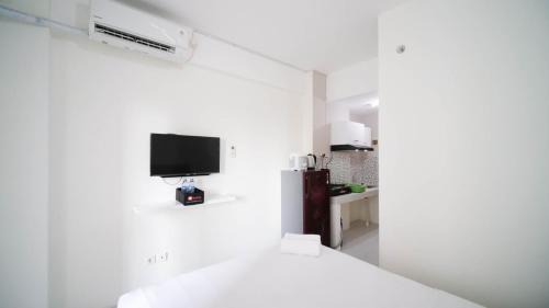 Surabaya Apartment | Compact and Tidy Studio at Puncak Dharmahusada Apartment By Travelio