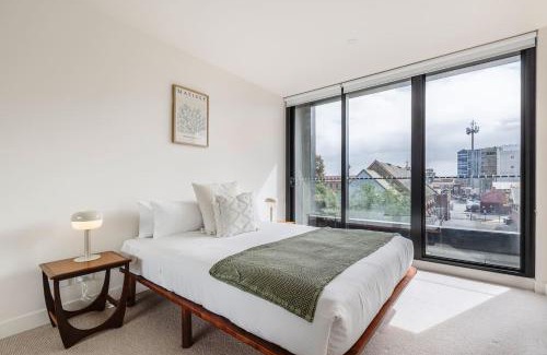 Brunswick Apartment | Concrete Junction - Sunny, Industrial Balcony Haven