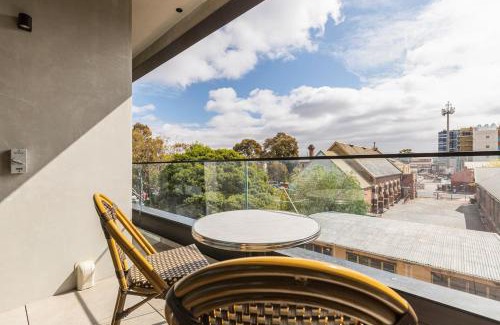 Brunswick Apartment | Concrete Junction - Sunny, Industrial Balcony Haven