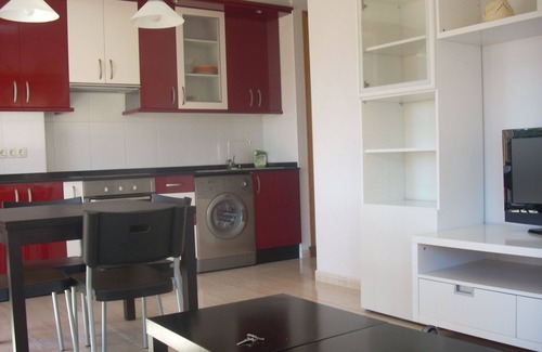 Puebla del Caraminal Apartment | Cosy apartment with colourfully decorated and brightly lit living room