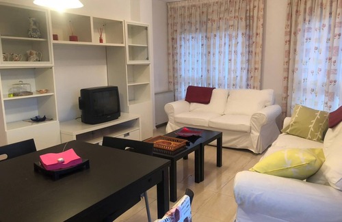 Puebla del Caraminal Apartment | Cosy apartment with colourfully decorated and brightly lit living room