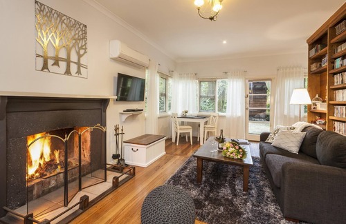 Olinda Cottage | Cottage In The Forest - Relax in your King size bed looking out onto the forest, curl up on the lounge with open wood fire.