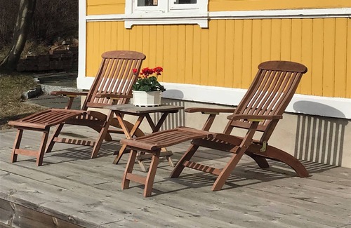Boo House | Cottage with sunny wooden deck by water. Rowing boat included.
