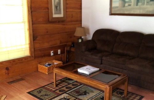 Oneida Cabin | cozy cabin in the woods in a relaxing area with wrap around porch rocking chairs