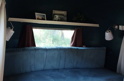 Larkspur House | Cozy camper by the creek, surrounded by serenity and nature.