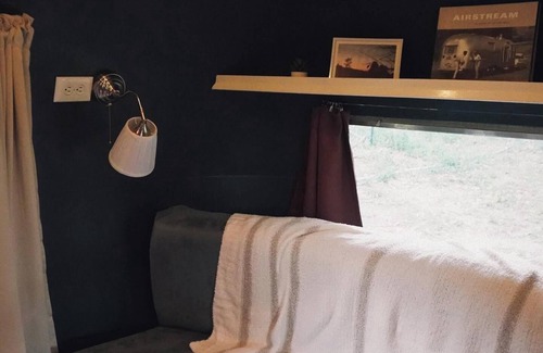 Larkspur House | Cozy camper by the creek, surrounded by serenity and nature.