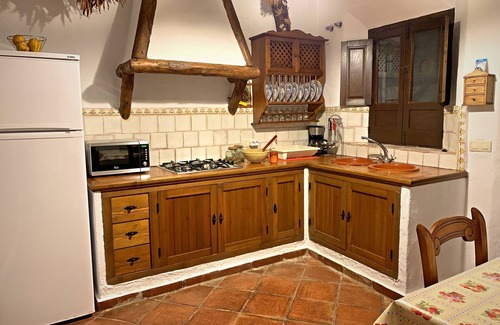 Zahara de la Sierra Cottage | Cozy House in Zahara de la Sierra, Cádiz: Fireplace and Castle Views