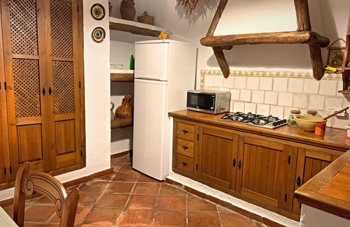 Zahara de la Sierra Cottage | Cozy House in Zahara de la Sierra, Cádiz: Fireplace and Castle Views