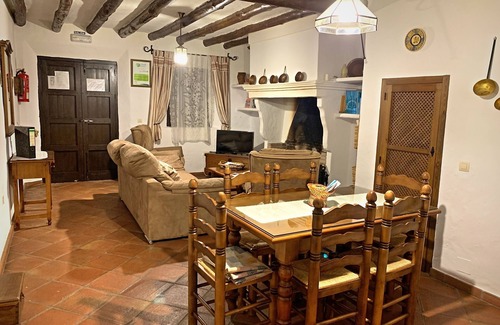 Zahara de la Sierra Cottage | Cozy House in Zahara de la Sierra, Cádiz: Fireplace and Castle Views