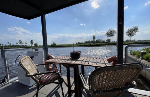 Steenwijk Boat Rental | Cozy Houseboat in Steenwijk near Giethoorn