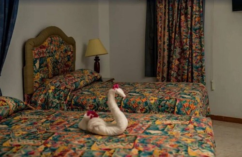 Runaway Bay Resort | Deluxe Quadruple Room, 2 Queen Beds, Garden View
