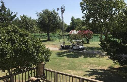 Edmond Cabin | Enjoy our loft with a private hot tub overlooking the vineyard and pond.