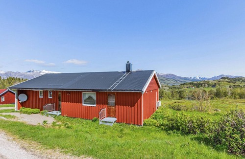 Steigen House | Enjoy the view of mountains and forests in this cozy vacation home.