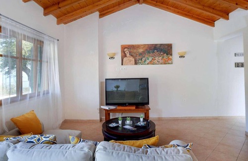 Longos House | From its elevated position directly above Levrecchio beach, this wonderfully light and airy villa en