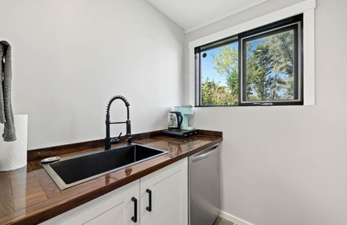Kamloops House | Guest suite with patio that backs onto greenbelt