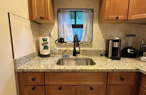 Poiciana Park II Cottage | Historic charm meets modern comfort—your cozy stay for work or play.