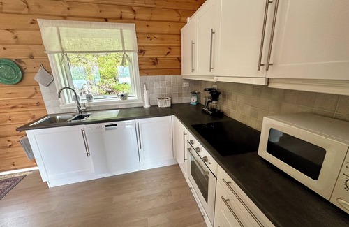 Hareid Cabin | Holyday home (2016-built) with view plot beyond Fjord and Mountains.