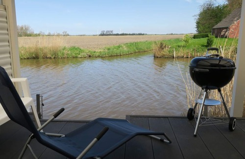 Eilsum House | House on the canal near Greetsiel, rowing boat fishing directly from the jetty, pets allowed
