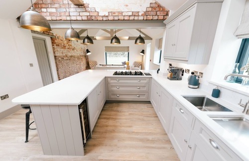 Nantwich House | Imagine relaxing on a spacious corner sofa, wrapped in the warmth of your loved ones, as the gentle crackle of a log burner fills the room. Picture yourself unwinding in a hot tub at sunset, drink in hand, with the stresses of the week melting away.