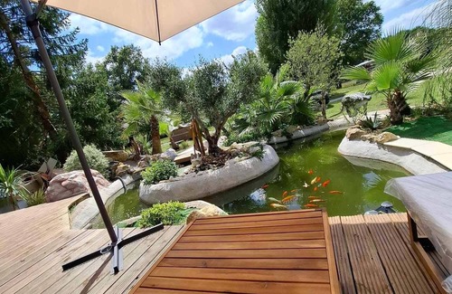 Marsas Cabin | Jurassic cottage in a green setting with koi pond