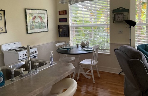 New Smyrna Beach Cottage | Kingfisher Cottage on Canal and two blocks to Ocean, amidst a tropical landscape