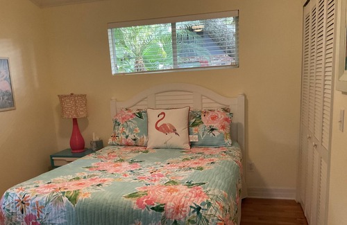 New Smyrna Beach Cottage | Kingfisher Cottage on Canal and two blocks to Ocean, amidst a tropical landscape