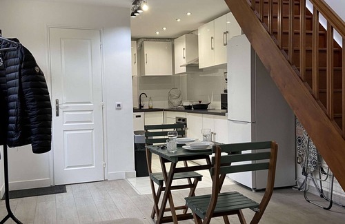 Saint-Brice-sous-Foret Apartment | L'appartement dispose d'un lit, d'un canapé-lit et d'une cuisine avec un réfrigérateur