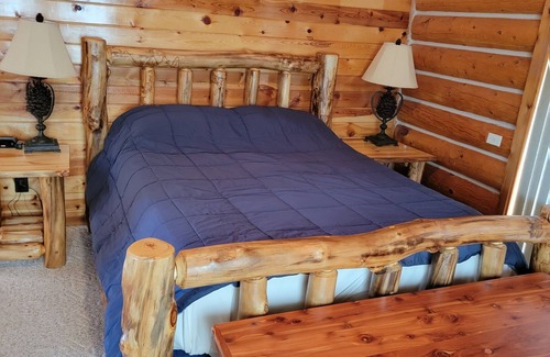 Hulett House | Large garage for bikes. Beautiful log home. On golf course.
