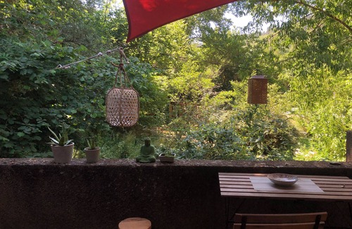 Rennes-les-Bains Apartment | Like a cabin, between forest and river, with a terrace facing the garden.