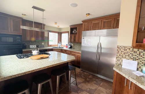 Maple City Cabin | Lodge-style multi-level home at the Homestead in Glen Arbor. Deck with grill.