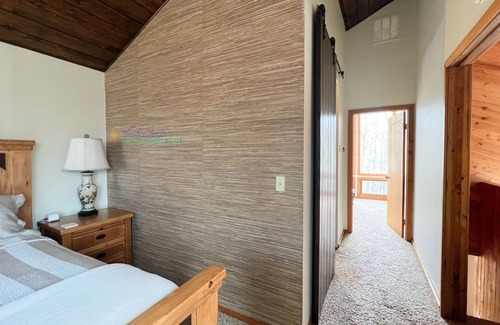 Maple City Cabin | Lodge-style multi-level home at the Homestead in Glen Arbor. Deck with grill.