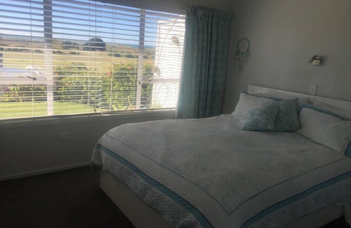 Waihi Beach House | Lovely sunny home with beach views to the front and county views at the back.