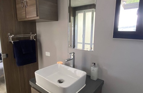 Oberon House | Luxury Caravan, Complimentary welcome cheese platter & a bottle of wine.