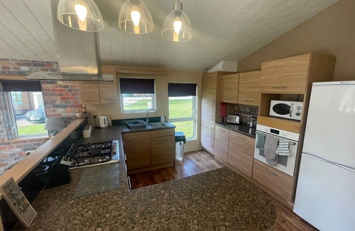 Tattershall Cabin | luxury lakeside lodge with a sunken hot tub on bull rush a peaceful feature lake @Tattershall lakes